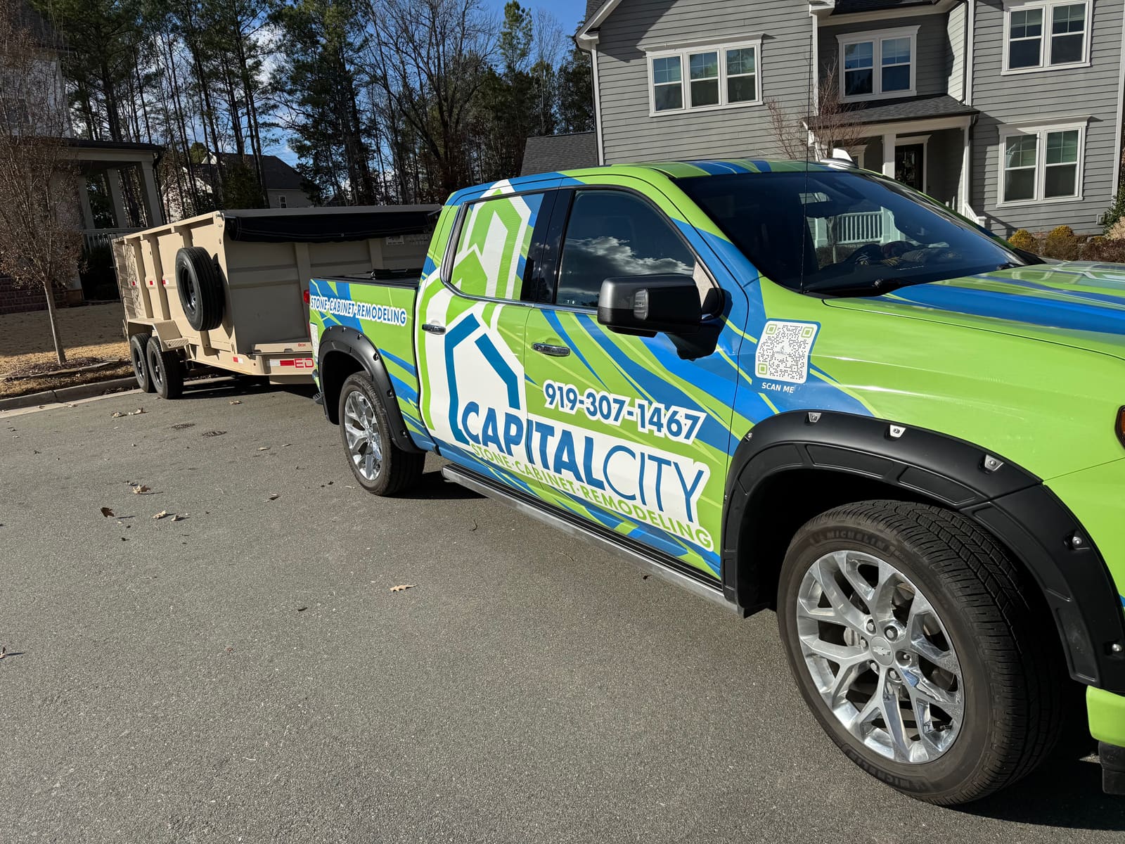 Capital City Stone and Cabinet Design wrapped work truck and trailer at a job site