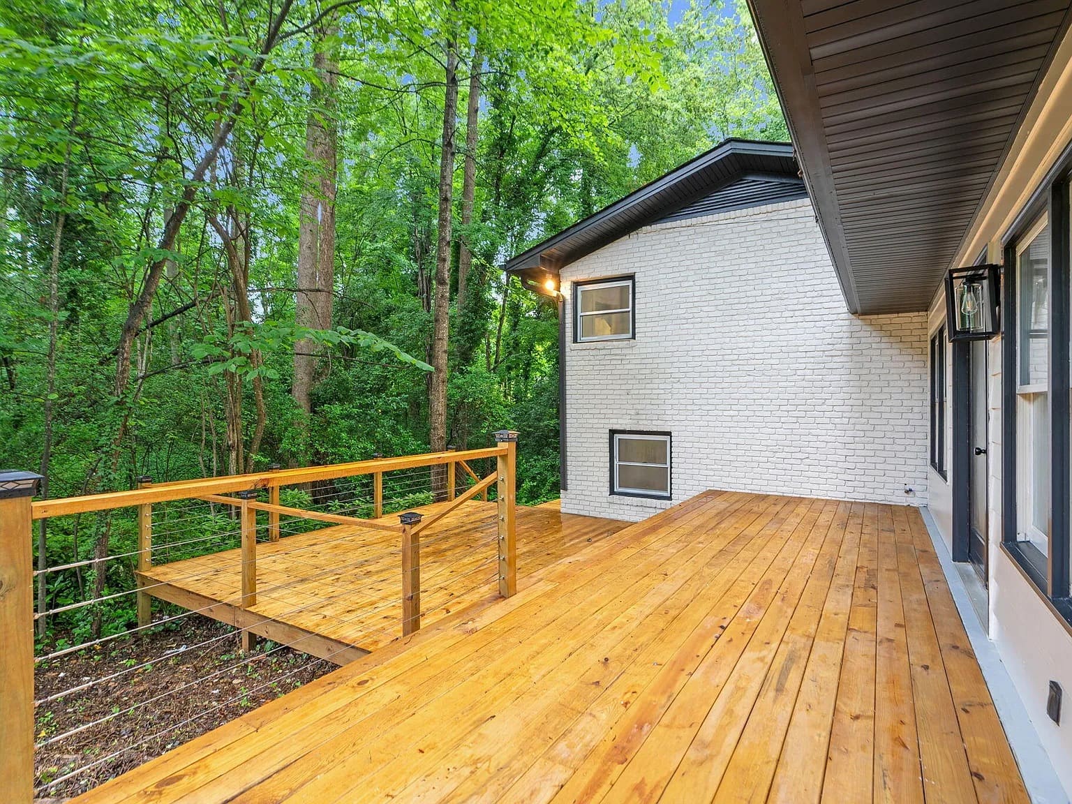 Newly built cedar deck on a white brick home